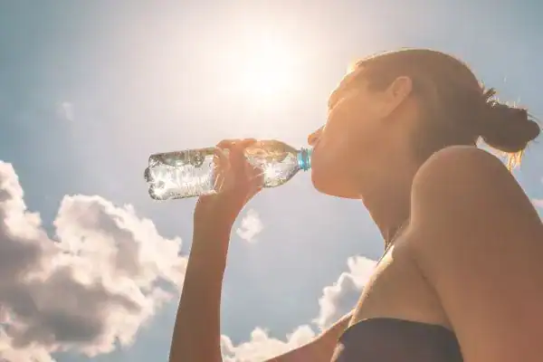 Hydration: The Secret Ingredient for a Toned Stomach and Enhanced Fitness 3 Image of woman drinking water to hydrate Leigh-on-Sea after run.