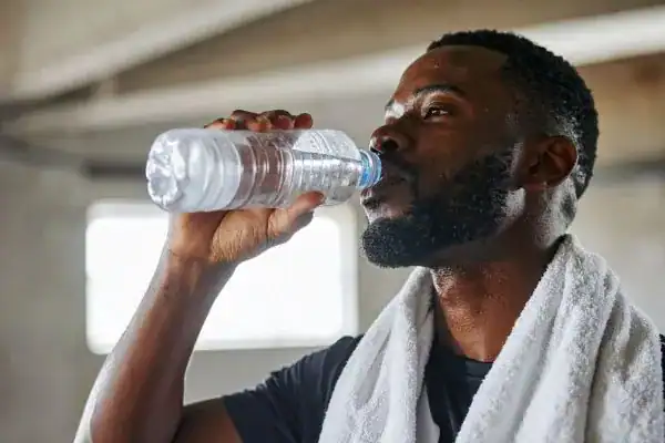 Image of man drinking water to improve hydration Leigh-on-Sea after work out.